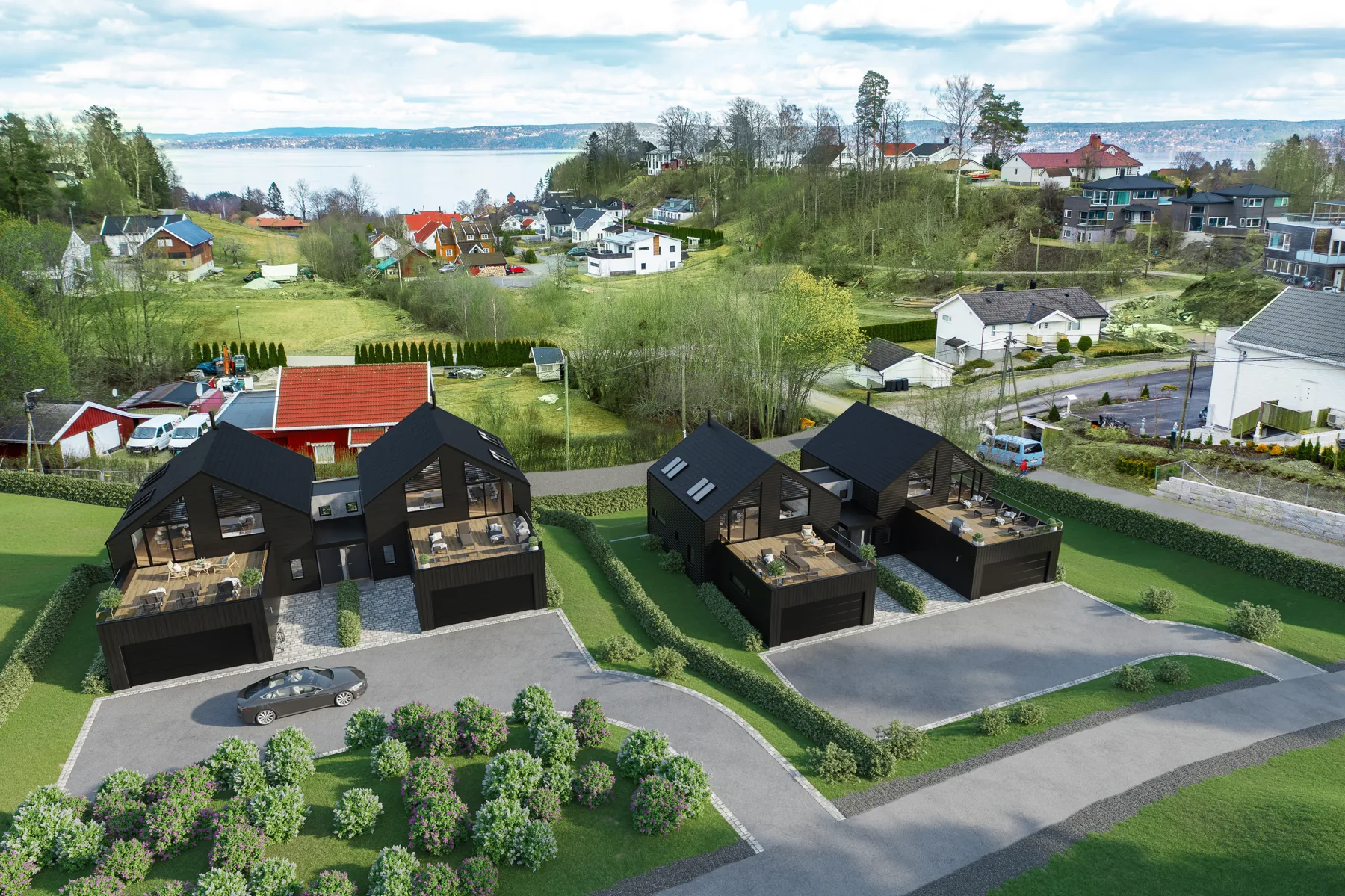 3D aerial rendering of dark timber townhouses with a parking area on a hillside above a village and water