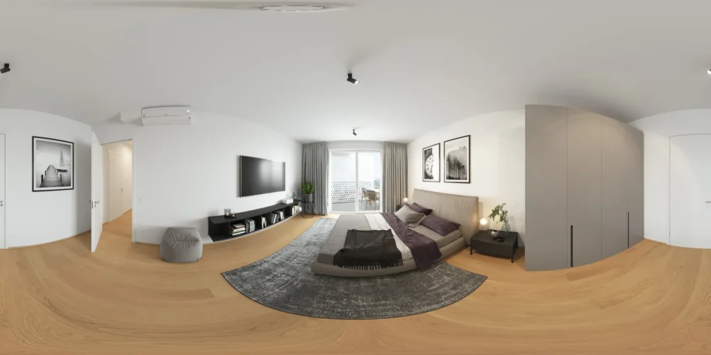 Tour virtual 360 grados de una sala de estar con un sofá esquinero gris y un televisor montado en la pared, Austria