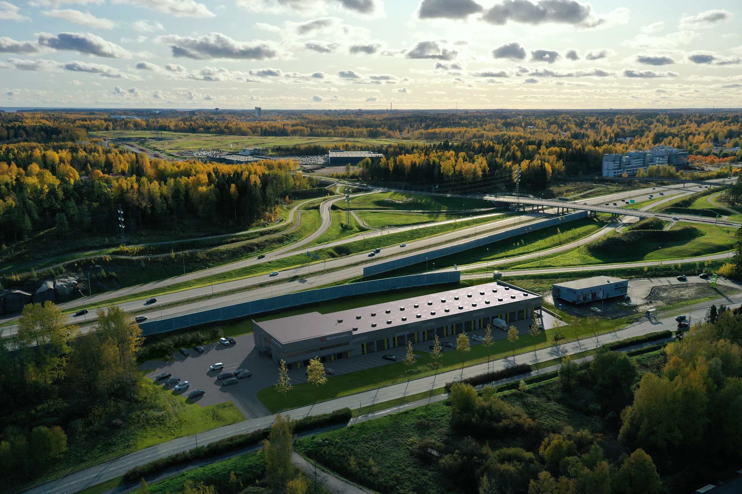 Aerial of a logistics building beside a motorway showing its access and yard, Finland