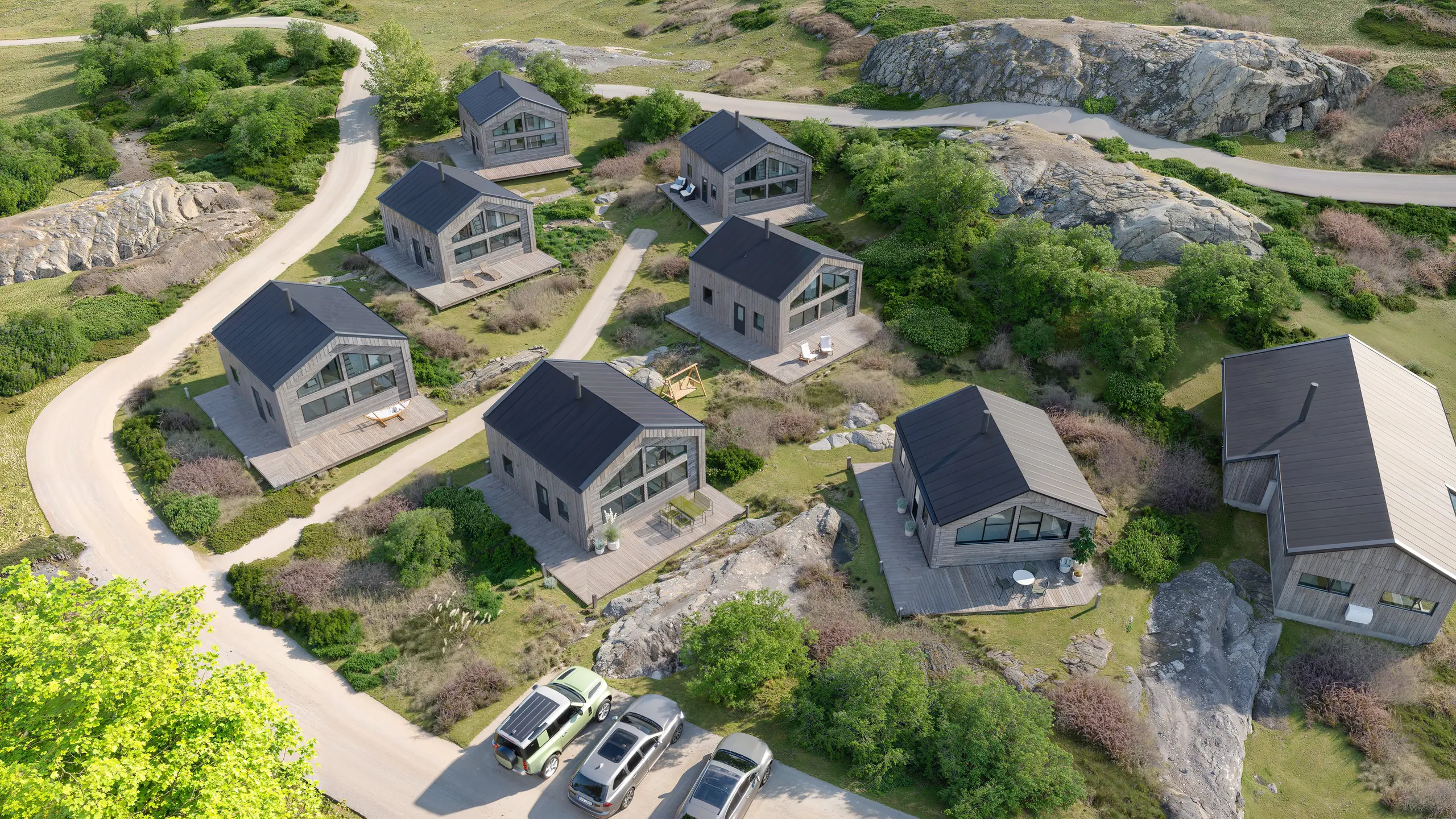 Aerial rendering of a village of cabins in its landscape, Norway