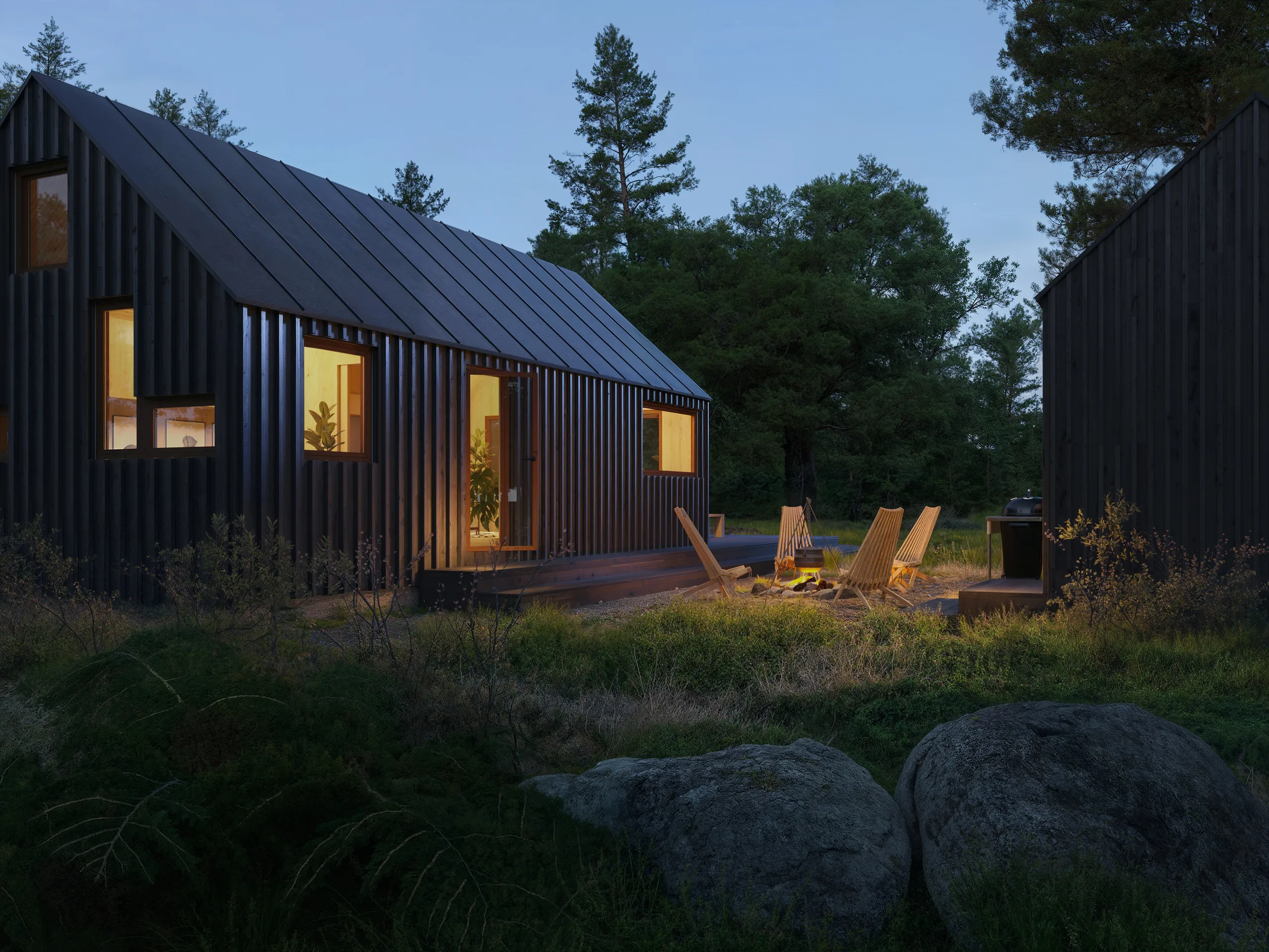 3D exterior rendering of a black timber cabin at dusk with lit windows and chairs around a fire pit, Norway