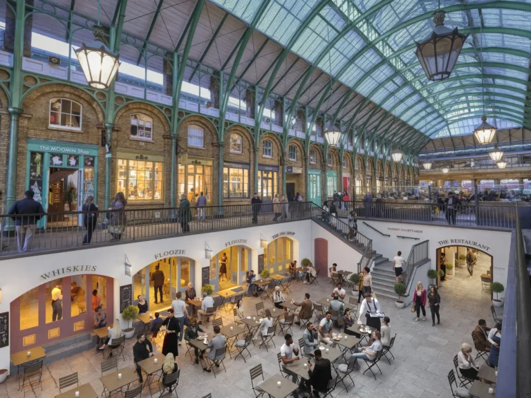3D rendering of a glazed Victorian market hall with cafe seating and shoppers below, UK