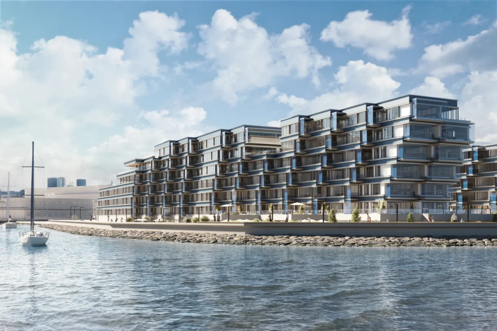 3D exterior rendering of a waterfront apartment development seen from the sea, with a sailing boat and the Tallinn skyline behind, Estonia