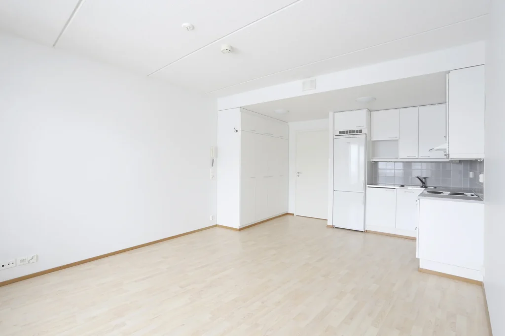 Empty apartment before virtual staging, open-plan kitchen and dining area, Finland